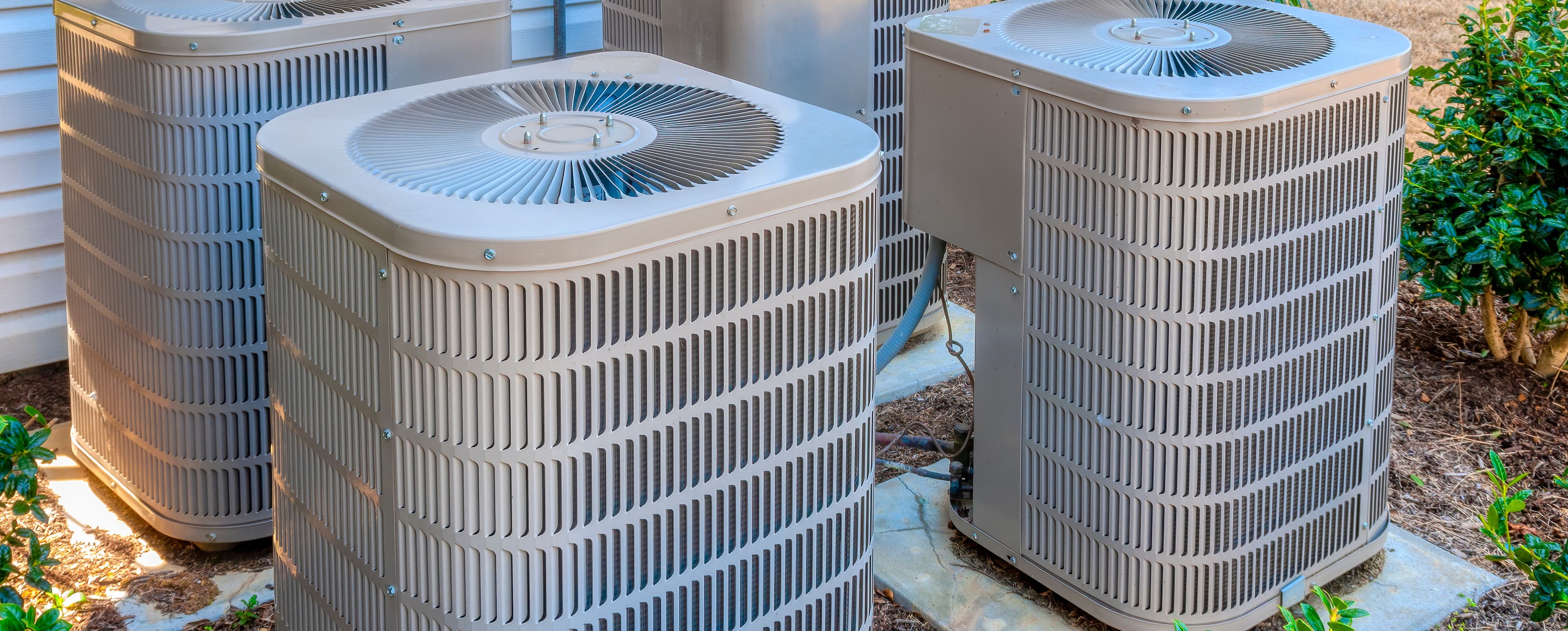 Residential HVAC condenser units outside an Iowa home